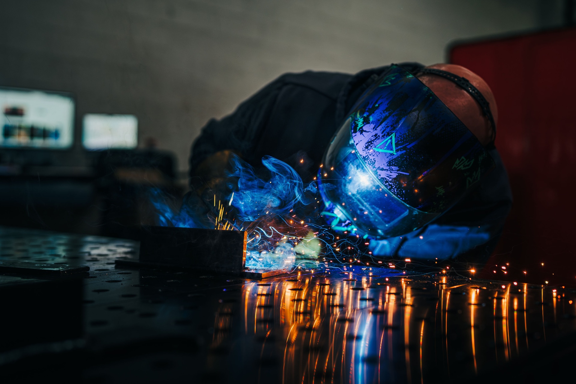 Welder working a production fixture